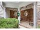 Covered entryway featuring stone flooring, wood beams, and a decorative birdhouse at 240 Rose Ridge Dr, Canton, GA 30115
