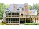 Expansive backyard featuring a deck, a screened-in porch, and brick chimneys at 240 Rose Ridge Dr, Canton, GA 30115