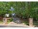 Long driveway leading to a grand home surrounded by mature trees at 240 Rose Ridge Dr, Canton, GA 30115