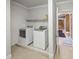 Utility/laundry room featuring front loading washer and dryer, as well as storage shelving at 240 Rose Ridge Dr, Canton, GA 30115