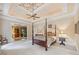 Serene main bedroom with a decorative ceiling, four-poster bed, and comfortable furnishings at 240 Rose Ridge Dr, Canton, GA 30115