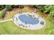 Large covered pool with patio, green grass, plenty of seating and lush landscaping at 240 Rose Ridge Dr, Canton, GA 30115