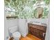 Charming powder room showcases decorative wallpaper, wainscoting, and vintage fixtures at 240 Rose Ridge Dr, Canton, GA 30115