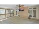 Spacious screened porch with brick accent wall, ceiling fan and outdoor television at 240 Rose Ridge Dr, Canton, GA 30115