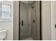 Modern bathroom featuring a tiled shower with a glass door at 2721 Old Concord Se Rd, Smyrna, GA 30082