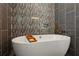 Luxurious bathroom with a freestanding tub and decorative accent wall at 2721 Old Concord Se Rd, Smyrna, GA 30082