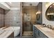 Stylish bathroom featuring a glass shower, soaking tub, and gray vanity with marble countertop at 2721 Old Concord Se Rd, Smyrna, GA 30082