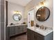 Double sink bathroom with round mirrors, stylish vanity, and bronze fixtures at 2721 Old Concord Se Rd, Smyrna, GA 30082