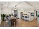 Open-concept dining room with modern light fixtures, a wooden table, and views into the kitchen at 2721 Old Concord Se Rd, Smyrna, GA 30082