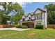 Charming two-story home with a second story balcony, covered porch, manicured lawn, and wood accents at 2721 Old Concord Se Rd, Smyrna, GA 30082