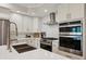 Bright, modern kitchen featuring stainless steel appliances, stone countertops, and white cabinets at 2721 Old Concord Se Rd, Smyrna, GA 30082