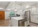 Bright open kitchen featuring a center island, stainless steel appliances, and hardwood floors at 2721 Old Concord Se Rd, Smyrna, GA 30082