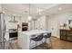 Modern kitchen featuring a center island, white cabinets, stainless steel appliances, and a tile backsplash at 2721 Old Concord Se Rd, Smyrna, GA 30082