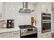 Modern kitchen featuring stainless steel appliances, gas range, stylish backsplash, and white countertops at 2721 Old Concord Se Rd, Smyrna, GA 30082