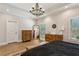 Serene bedroom retreat with hardwood floors, tray ceiling, natural light, and rustic wood furnishings at 2721 Old Concord Se Rd, Smyrna, GA 30082