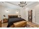 Serene bedroom retreat with hardwood floors, tray ceiling, natural light, and rustic wood furnishings at 2721 Old Concord Se Rd, Smyrna, GA 30082