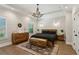 Serene bedroom retreat with hardwood floors, tray ceiling, natural light, and rustic wood furnishings at 2721 Old Concord Se Rd, Smyrna, GA 30082