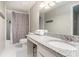 Bathroom with a granite countertop, modern fixtures, and a shower-tub combo at 5245 Chemin De Vie, Atlanta, GA 30342