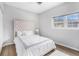Bright bedroom with a large window, hardwood flooring, and a tufted headboard at 5245 Chemin De Vie, Atlanta, GA 30342