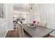 Formal dining area with hardwood floors, chandelier, and view to the living room at 5245 Chemin De Vie, Atlanta, GA 30342