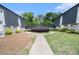 Attractive townhouse complex with manicured landscaping and a walkway on a sunny day at 5245 Chemin De Vie, Atlanta, GA 30342