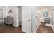 Hallway view of ensuite bathroom featuring a white vanity and tiled floors at 5245 Chemin De Vie, Atlanta, GA 30342