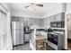 Modern kitchen with stainless steel appliances, gray cabinets, and tile flooring at 5245 Chemin De Vie, Atlanta, GA 30342