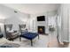 Living room with fireplace, stylish seating, and French doors to another room at 5245 Chemin De Vie, Atlanta, GA 30342