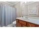 Well-lit bathroom with a shower-tub combo, a stylish vanity, and contemporary fixtures at 7493 Elderberry Dr, Douglasville, GA 30135