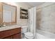 Bathroom with single vanity, granite countertop, shower-tub combination, and a framed mirror at 7493 Elderberry Dr, Douglasville, GA 30135