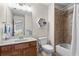 Bright bathroom featuring a vanity with a wood cabinet and a shower-over-tub with tile surround at 7493 Elderberry Dr, Douglasville, GA 30135