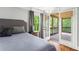 Cozy bedroom with a view to the screened-in porch, neutral decor, and a calming ambiance at 7493 Elderberry Dr, Douglasville, GA 30135