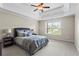 Primary bedroom with tray ceiling, large window for natural light and plush neutral carpet at 7493 Elderberry Dr, Douglasville, GA 30135