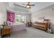 This bedroom features carpet, a ceiling fan, a dresser, and a desk at 7493 Elderberry Dr, Douglasville, GA 30135