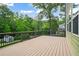Expansive wooden deck overlooking a private backyard with lush greenery and a storage shed at 7493 Elderberry Dr, Douglasville, GA 30135