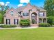 Charming brick home with a well-manicured lawn and mature landscaping at 7493 Elderberry Dr, Douglasville, GA 30135