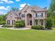Beautiful brick home featuring a manicured lawn, and stately architectural details at 7493 Elderberry Dr, Douglasville, GA 30135