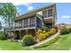 Rear exterior view of home featuring a multi-level deck, a screened porch, and a lush yard at 7493 Elderberry Dr, Douglasville, GA 30135