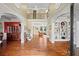 Elegant foyer with hardwood floors, archways, and view of the second floor at 7493 Elderberry Dr, Douglasville, GA 30135