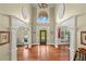 Grand two-story foyer with hardwood flooring and decorative columns at 7493 Elderberry Dr, Douglasville, GA 30135