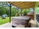 Outdoor hot tub on a concrete patio in a peaceful backyard setting with mature trees at 7493 Elderberry Dr, Douglasville, GA 30135