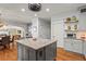 Open kitchen design featuring stainless steel appliances, center island with seating and hardwood floors at 7493 Elderberry Dr, Douglasville, GA 30135
