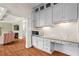 Bright kitchen area with white cabinets, granite countertops, and stainless steel microwave at 7493 Elderberry Dr, Douglasville, GA 30135
