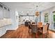 Open kitchen/dining area with hardwood floors, island with seating, and stainless steel appliances at 7493 Elderberry Dr, Douglasville, GA 30135