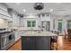 Modern kitchen features granite countertops, stainless steel appliances, and large center island at 7493 Elderberry Dr, Douglasville, GA 30135