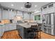 Kitchen features gray cabinets, granite counters, stainless appliances, and a functional center island at 7493 Elderberry Dr, Douglasville, GA 30135