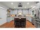 Gray kitchen boasts granite countertops, stainless steel appliances, and a central island at 7493 Elderberry Dr, Douglasville, GA 30135
