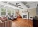 Bright and airy living room with fireplace, coffered ceiling, hardwood floors, and plenty of seating at 7493 Elderberry Dr, Douglasville, GA 30135