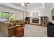 Comfortable living room showcasing a stone fireplace, a large window, and neutral color palette at 7493 Elderberry Dr, Douglasville, GA 30135