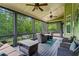 Relaxing screened porch with ceiling fans, outdoor seating, and views of the lush backyard at 7493 Elderberry Dr, Douglasville, GA 30135